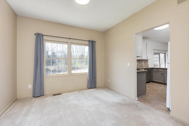 30701 Sandalwood Cir, Novi, MI 48377 - empty room with visible vents, light colored carpet, and baseboards