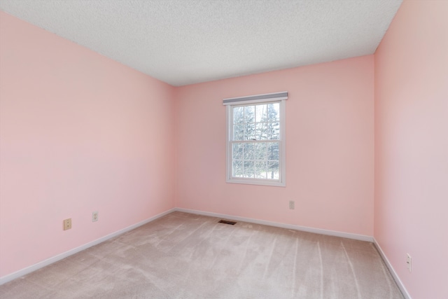 30701 Sandalwood Cir, Novi, MI 48377 - empty room with light colored carpet, visible vents, baseboards, and a textured ceiling