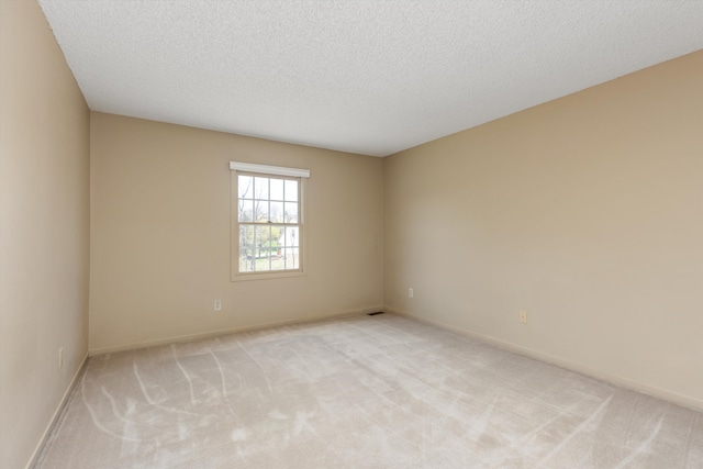30701 Sandalwood Cir, Novi, MI 48377 - spare room featuring a textured ceiling, visible vents, baseboards, and light carpet