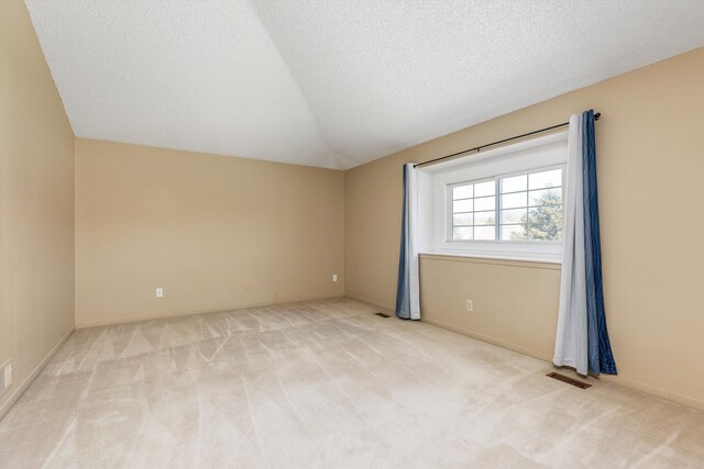 30701 Sandalwood Cir, Novi, MI 48377 - spare room featuring baseboards, visible vents, carpet flooring, and vaulted ceiling