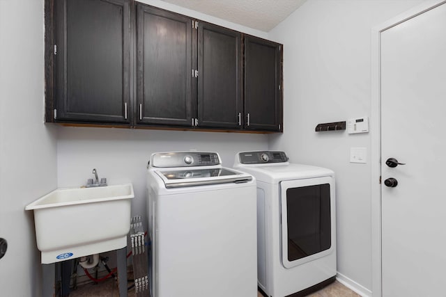 30701 Sandalwood Cir, Novi, MI 48377 - washroom with baseboards, a sink, cabinet space, and washing machine and dryer