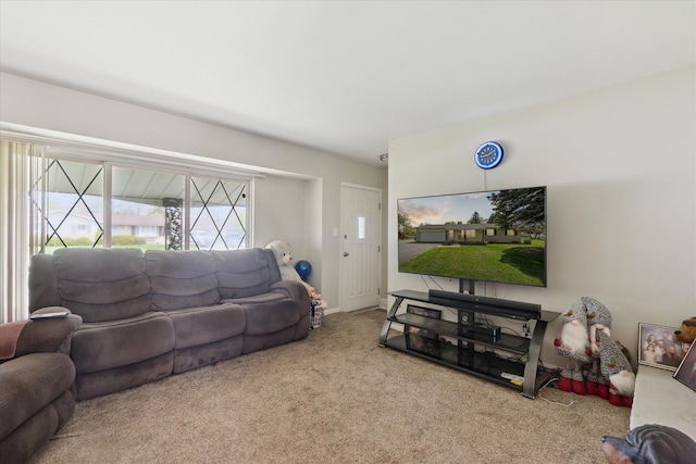 carpeted living area with baseboards