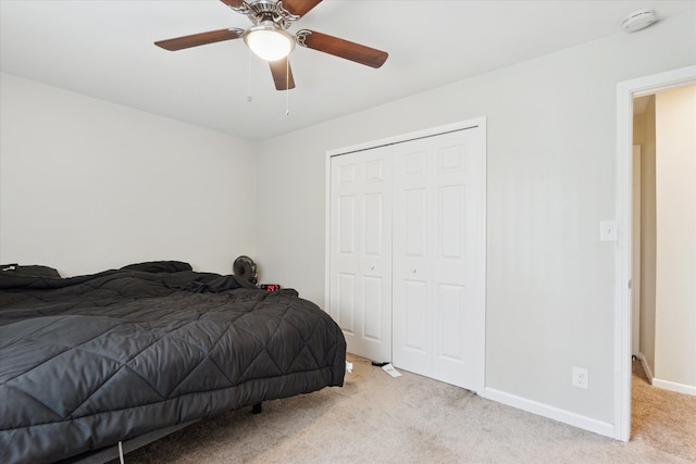 carpeted bedroom featuring baseboards, ceiling fan, and a closet