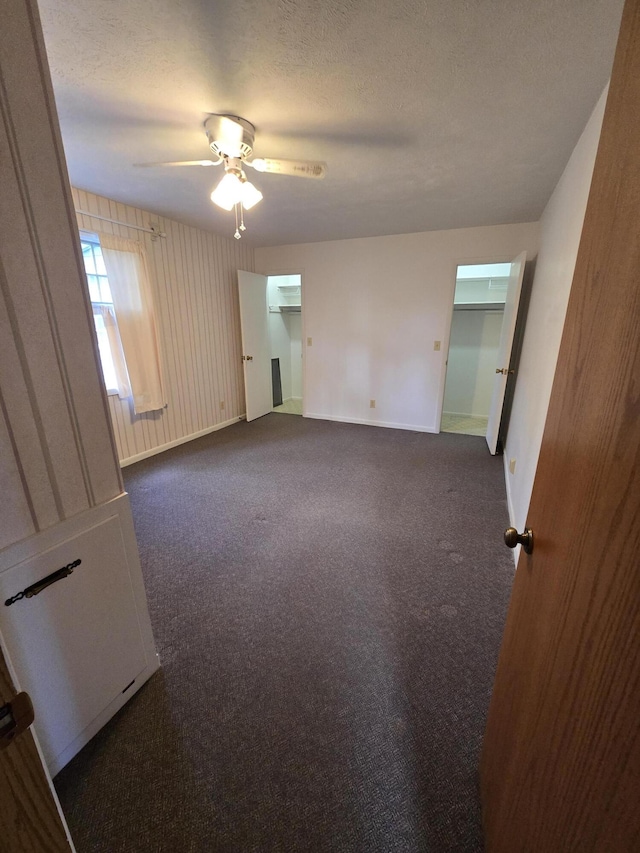 609 1st St, Lake Odessa, MI 48849 - interior space featuring ceiling fan, dark colored carpet, and baseboards