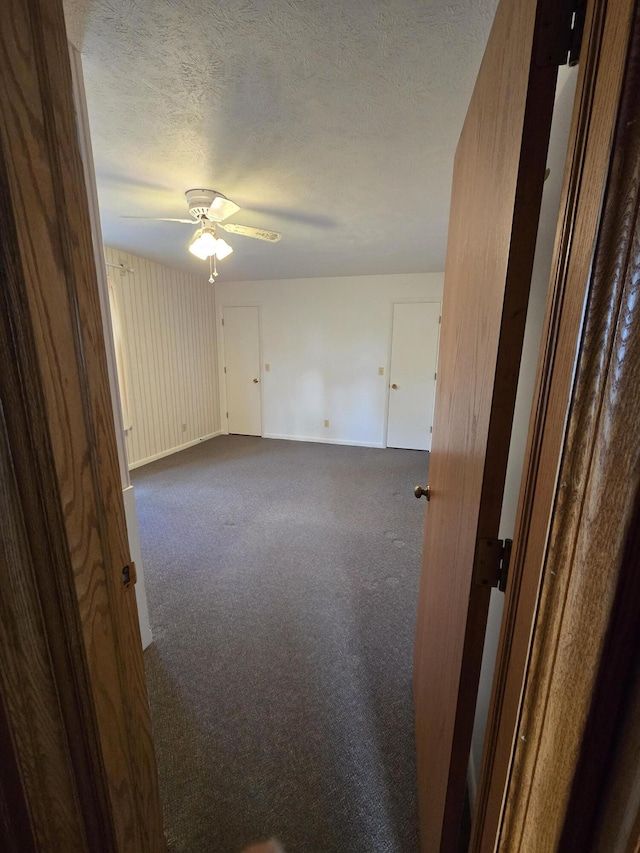 609 1st St, Lake Odessa, MI 48849 - carpeted empty room featuring a textured ceiling, ceiling fan, and baseboards