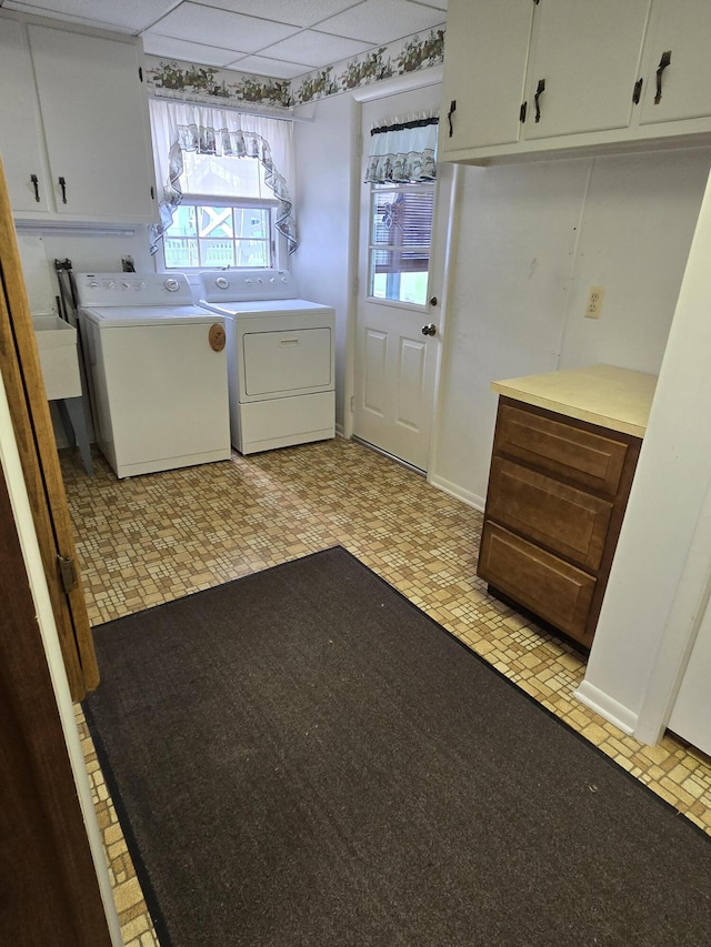 609 1st St, Lake Odessa, MI 48849 - laundry room featuring brick patterned floor, washing machine and clothes dryer, and cabinet space