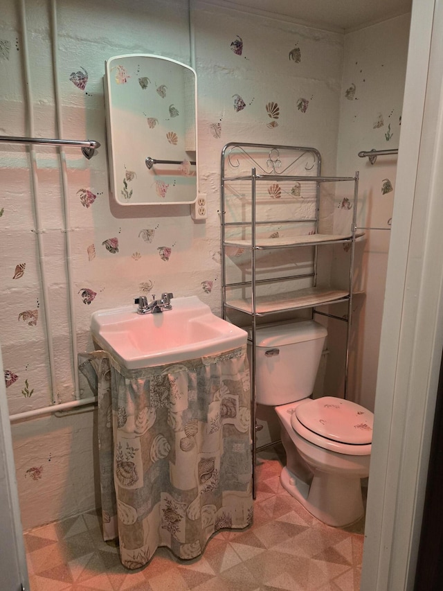 609 1st St, Lake Odessa, MI 48849 - bathroom with tile patterned floors and toilet