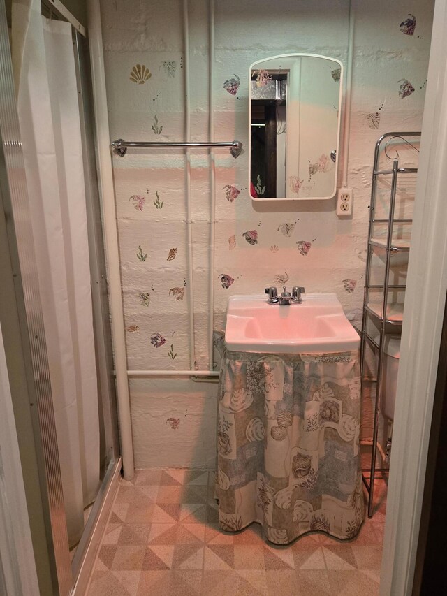 609 1st St, Lake Odessa, MI 48849 - bathroom with a sink and tile patterned floors