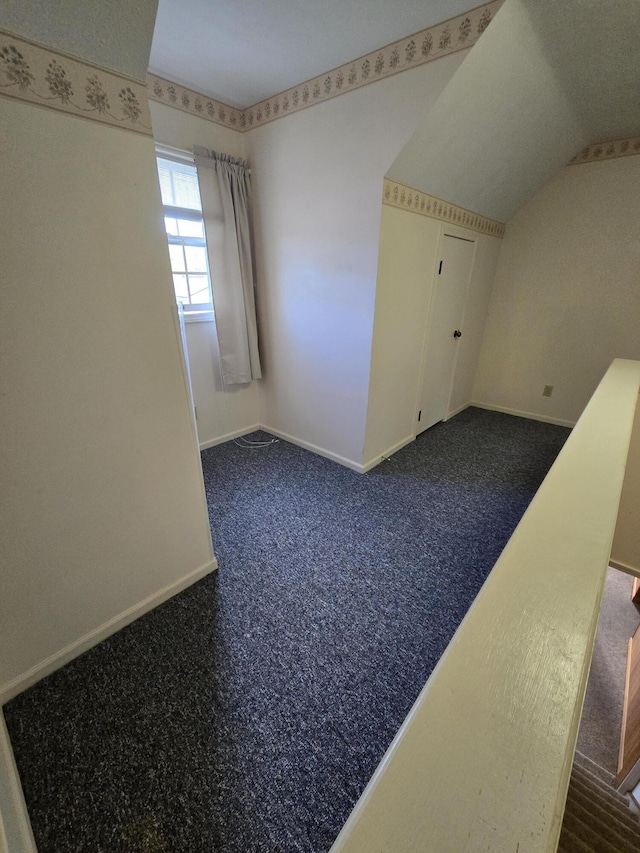609 1st St, Lake Odessa, MI 48849 - spare room featuring baseboards and vaulted ceiling