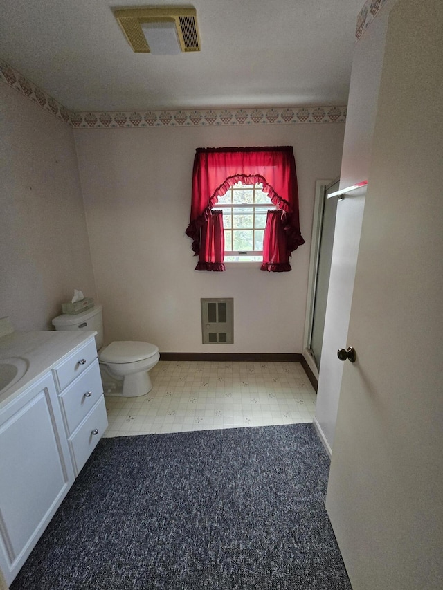 609 1st St, Lake Odessa, MI 48849 - full bath with an enclosed shower, visible vents, heating unit, toilet, and vanity