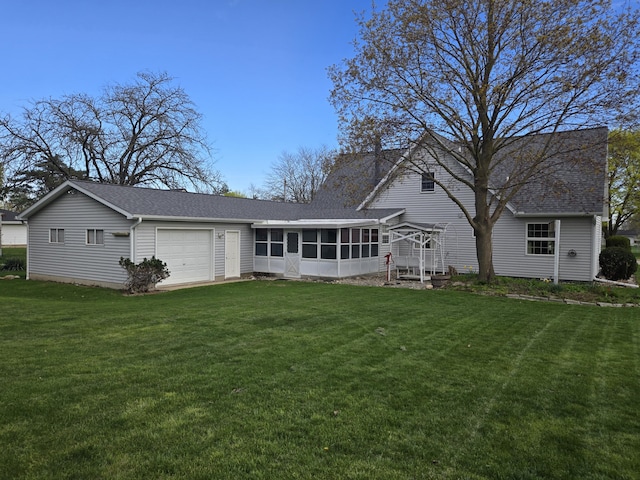 609 1st St, Lake Odessa, MI 48849 - back of property featuring a sunroom, a lawn, a garage, and a shingled roof
