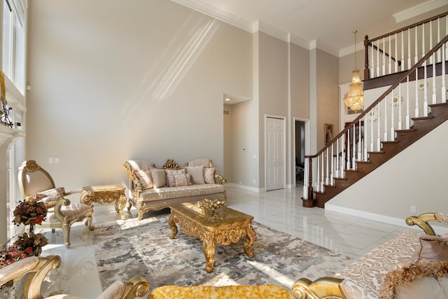 living area with stairway, a towering ceiling, marble finish floor, and baseboards