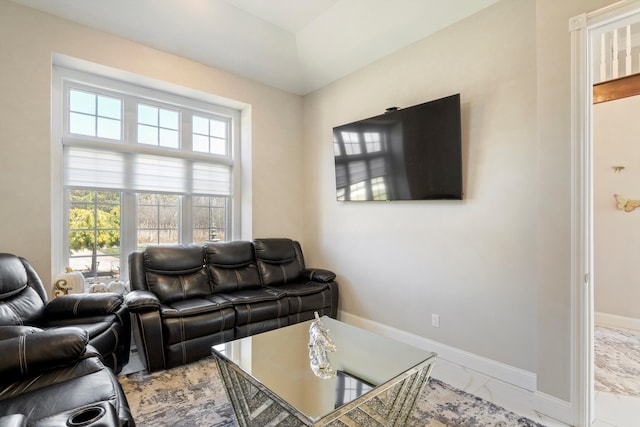 living room with baseboards and marble finish floor