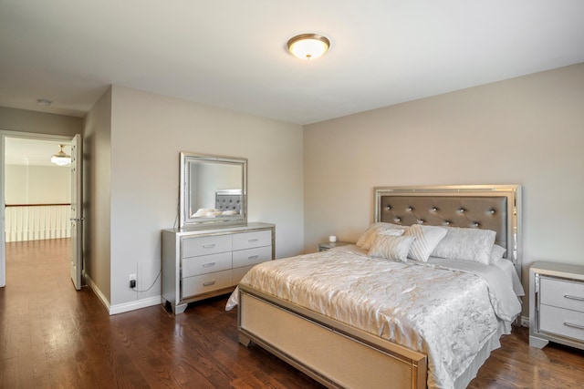 bedroom featuring dark wood-style flooring and baseboards