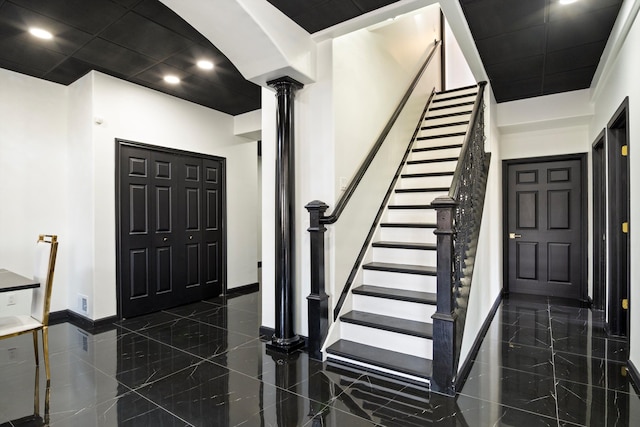 entryway with decorative columns, recessed lighting, stairs, and baseboards