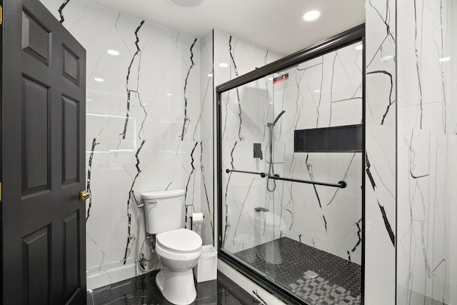 full bath with toilet, a marble finish shower, and tile walls