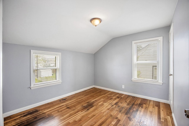 bonus room with hardwood / wood-style floors, baseboards, lofted ceiling, and plenty of natural light