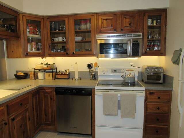 117 Vista Ct, Roscommon, MI 48653 - kitchen with light countertops, stainless steel appliances, glass insert cabinets, and a toaster