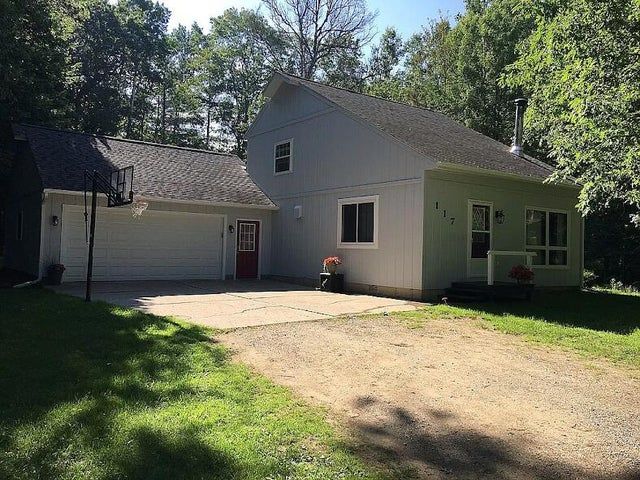 117 Vista Ct, Roscommon, MI 48653 - view of front of home with concrete driveway, an attached garage, roof with shingles, and a front lawn