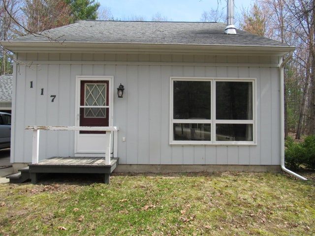 117 Vista Ct, Roscommon, MI 48653 - back of property featuring roof with shingles and a yard