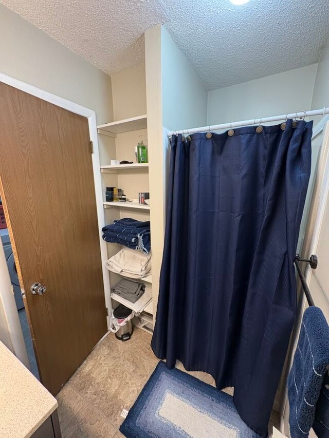 117 Vista Ct, Roscommon, MI 48653 - bathroom with a textured ceiling and curtained shower