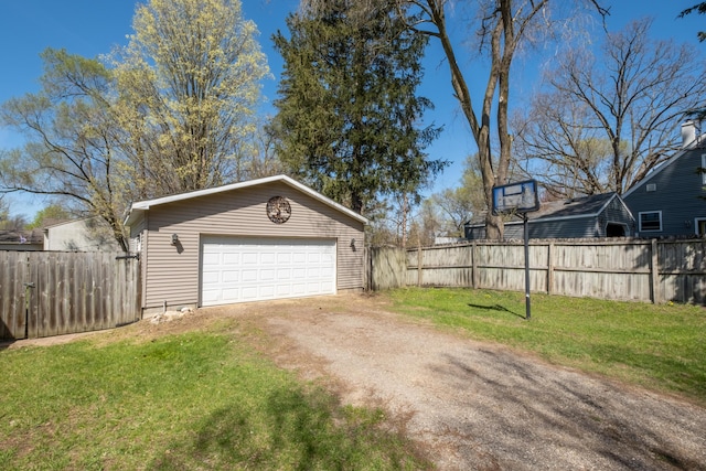 detached garage with fence and dirt driveway