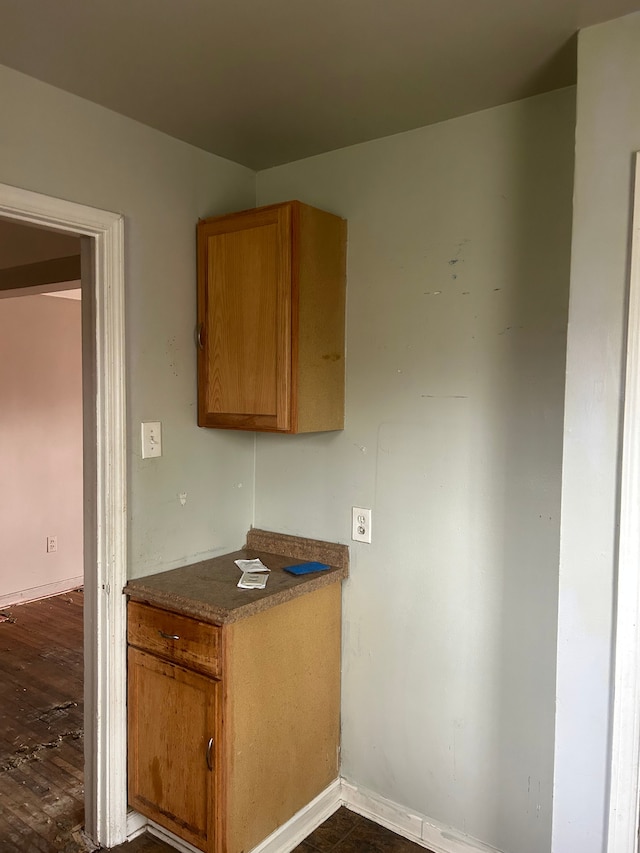 19483 Meyers Rd, Detroit, MI 48235 - kitchen with baseboards, dark wood-style floors, and brown cabinetry