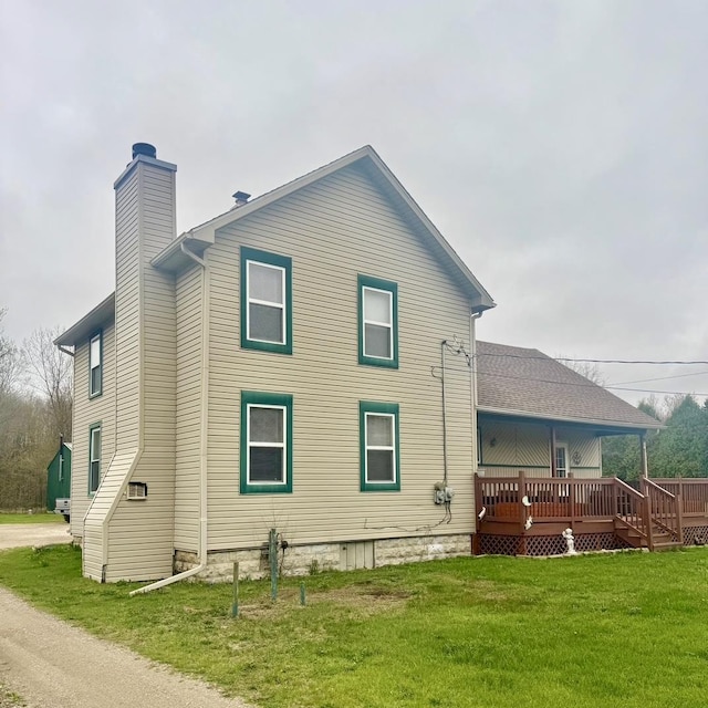 7850 Marsh Rd, Marine City, MI 48039 - rear view of house with a lawn, a wooden deck, and a chimney
