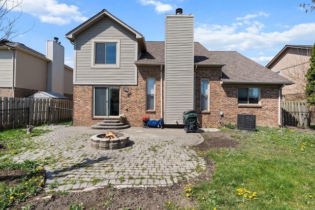25820 Lord Dr, Chesterfield, MI 48051 - back of property with a fire pit, a chimney, a patio area, and brick siding