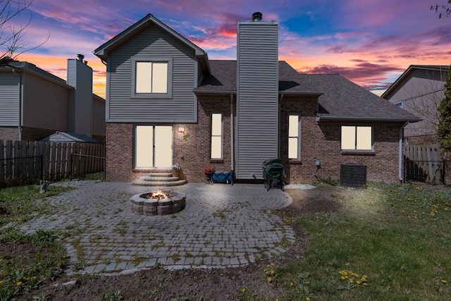 25820 Lord Dr, Chesterfield, MI 48051 - back of property featuring a patio, a chimney, an outdoor fire pit, brick siding, and a fenced backyard