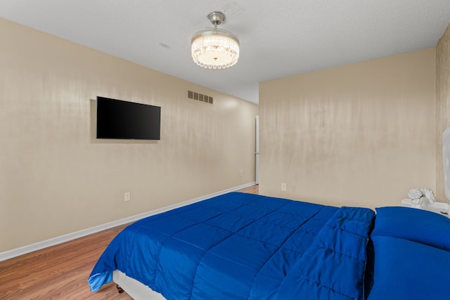 25820 Lord Dr, Chesterfield, MI 48051 - bedroom with baseboards, visible vents, and wood finished floors