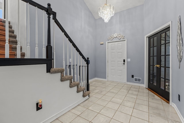 25820 Lord Dr, Chesterfield, MI 48051 - foyer entrance with a chandelier, light tile patterned flooring, stairs, visible vents, and a towering ceiling