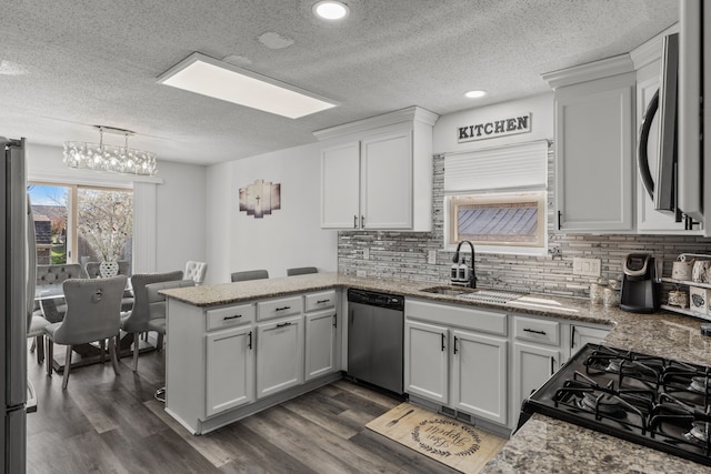 25820 Lord Dr, Chesterfield, MI 48051 - kitchen with tasteful backsplash, stainless steel appliances, a peninsula, and a sink