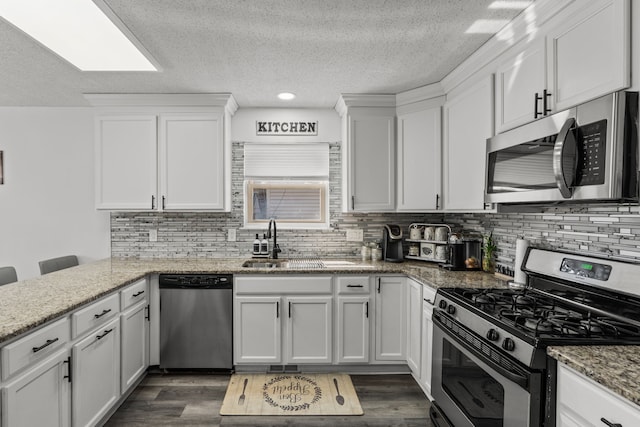 25820 Lord Dr, Chesterfield, MI 48051 - kitchen with a sink, decorative backsplash, white cabinetry, a textured ceiling, and appliances with stainless steel finishes