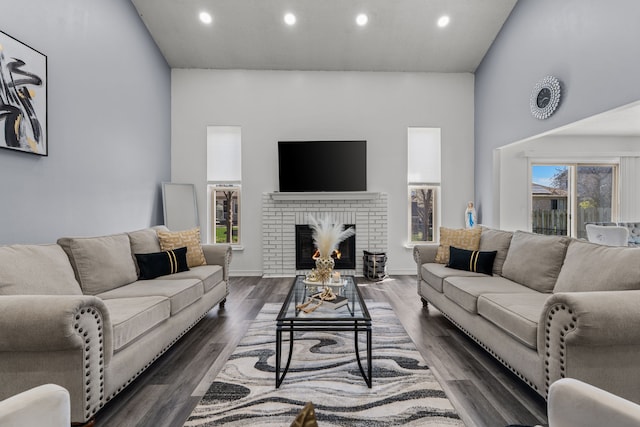 25820 Lord Dr, Chesterfield, MI 48051 - living area featuring a brick fireplace, recessed lighting, a high ceiling, and dark wood finished floors