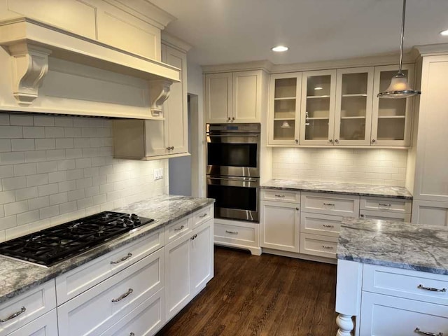 35315 Regency Ln, Farmington Hills, MI 48331 - kitchen with gas cooktop, stainless steel double oven, premium range hood, decorative backsplash, and glass insert cabinets