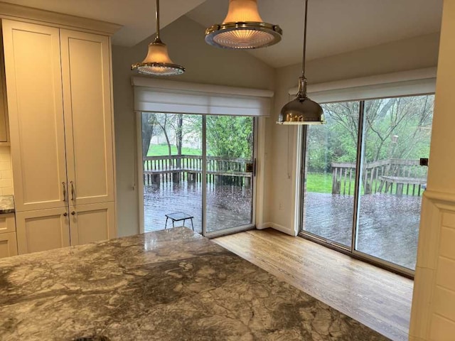 35315 Regency Ln, Farmington Hills, MI 48331 - unfurnished dining area with lofted ceiling and wood finished floors