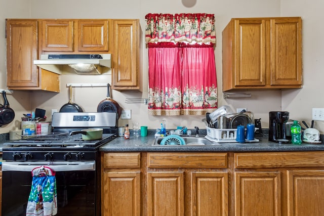 2602 Gratiot Ave, Port Huron, MI 48060 - kitchen with a sink, dark countertops, stainless steel range with gas stovetop, and under cabinet range hood