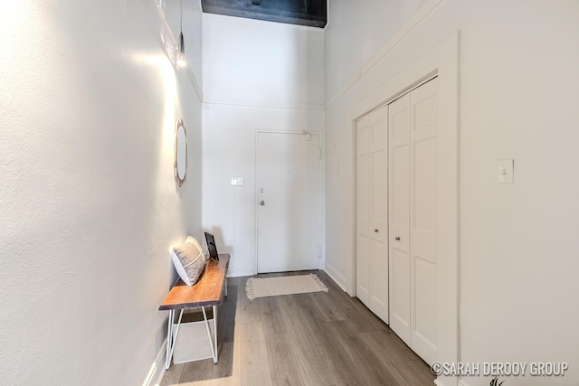 hallway with wood finished floors and baseboards