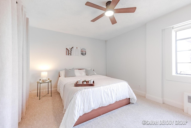 bedroom with ceiling fan, carpet flooring, and baseboards