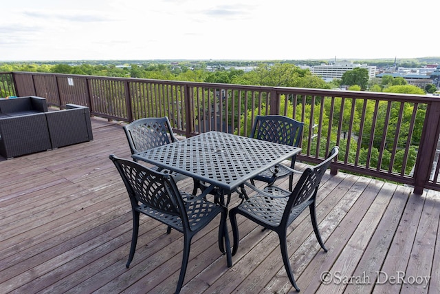wooden deck with an outdoor living space and outdoor dining space