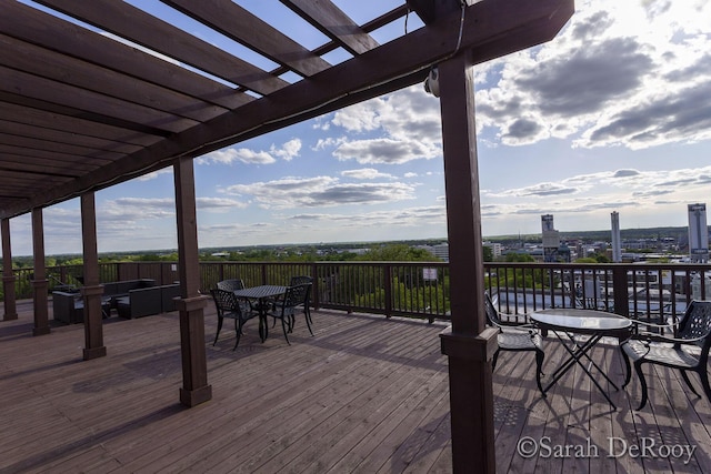 wooden terrace featuring a pergola and outdoor dining area