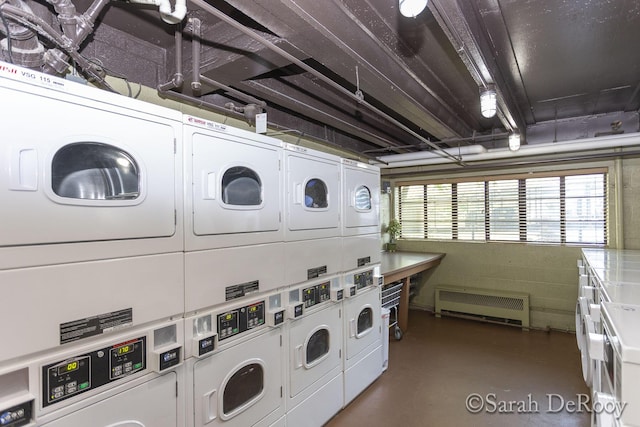 community laundry room featuring stacked washer and clothes dryer, separate washer and dryer, and radiator
