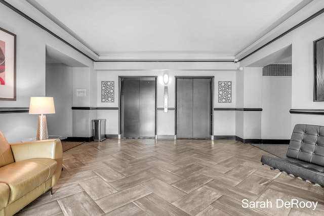 interior space featuring elevator and baseboards