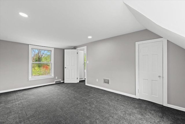 additional living space with dark carpet, recessed lighting, baseboards, and visible vents