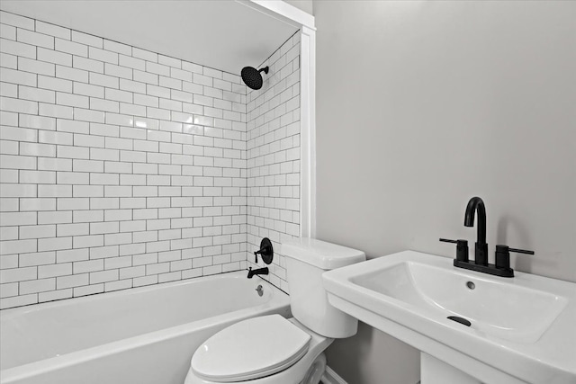 full bath featuring toilet, tub / shower combination, and a sink