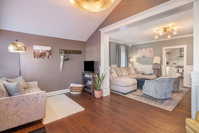 living area featuring a fireplace, ornamental molding, wood finished floors, and a wainscoted wall