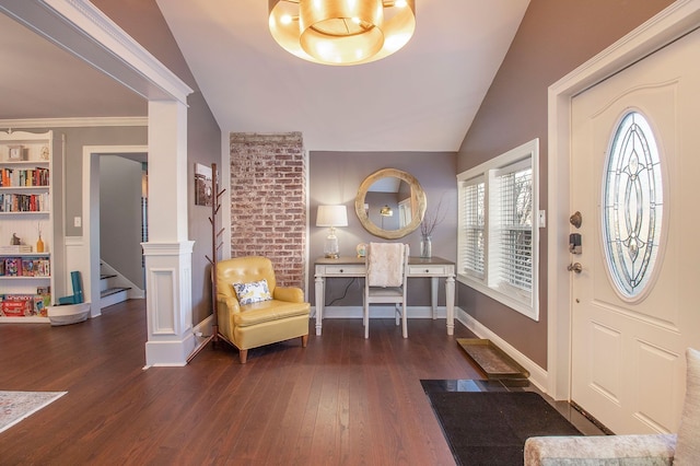 foyer entrance with baseboards, wood finished floors, vaulted ceiling, and stairway