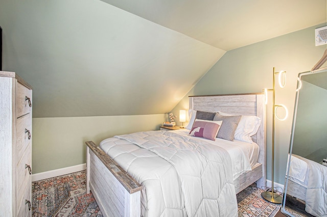 bedroom with baseboards and vaulted ceiling