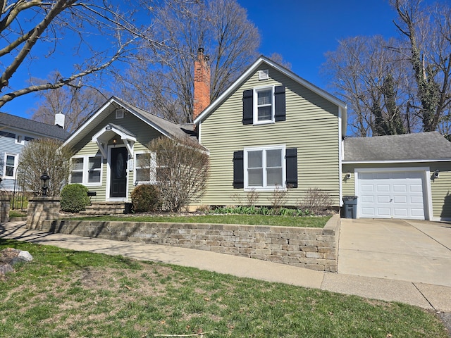 view of front facade with concrete driveway, an attached garage, and a chimney